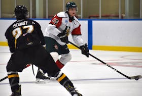Alexandre Tessier of the Halifax Mooseheads, right, looks towards the net as he's watched by Wynston Isheroff of the Cape Breton Eagles during Quebec Major Junior hockey League preseason action at Miners Forum in Glace Bay on Wednesday. Cape Breton won the game 2-1.
