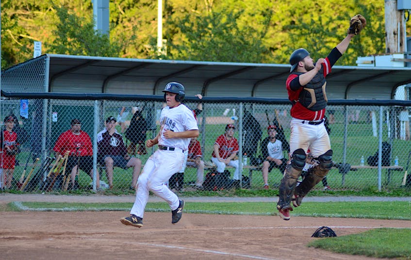 Summerside Toombs and MacDougall CPA Chevys catcher Jayden MacLean jumps to catch a throw as Dylan Worth of the Capital District Islanders scores in the bottom of the first inning of Game 2 of the Island Junior Baseball League final Aug. 24 at Memorial Field in Charlottetown. - Jason Malloy