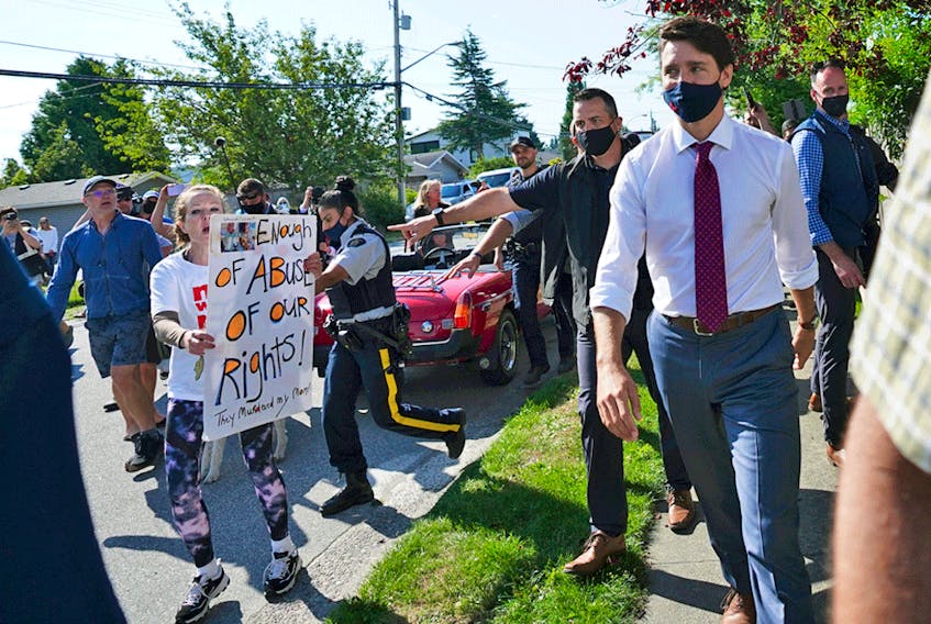 A protester yells at Liberal Leader Justin Trudeau as he campaigns in Surrey, B.C., on Wednesday, Aug 25, 2021.