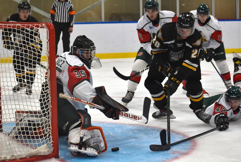 Halifax Mooseheads goaltender Adam Tkacz, left, makes a right pad save on Davis Cooper of the Cape Breton Eagles, middle, in close during Quebec Major Junior hockey League preseason action at Miners Forum in Glace Bay on Wednesday. Cape Breton won the game 2-1. JEREMY FRASER/CAPE BRETON POST