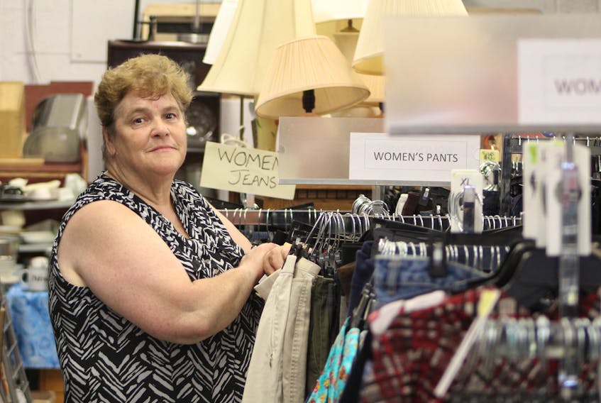 Betty Begg-Brooks stands next to some of the clothing that will be on sale Aug. 28 at Gifts From The Heart. For one day a month, Begg-Brooks sells items as a fundraiser to for the organization. 