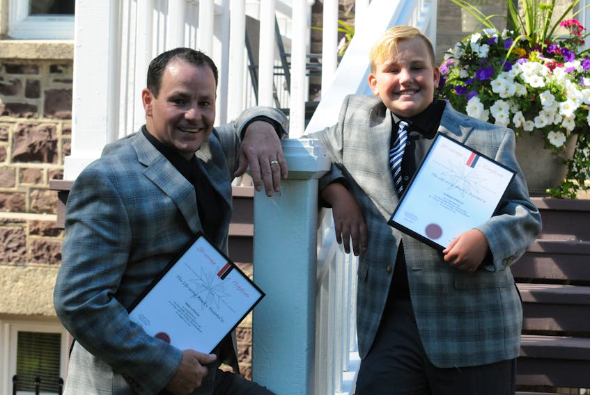 Mike Upshall and his 10-year-old Parker, both of Torbay, received life-saving awards at Government House. Joe Gibbons/The Telegram
