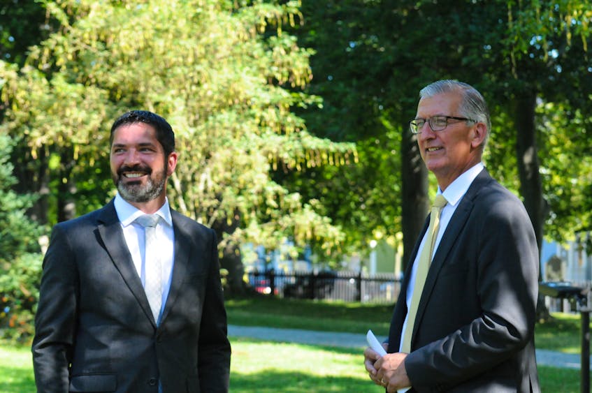 Gordon Payne (left) of St. John’s, chats with former Newfoundland and Labrador premier Paul Davis on the grounds of Government House in St. John's. In May 2021, Payne also used abdominal thrusts to save Davis when he began choking at a restaurant in Trinity. — Joe Gibbons/The Telegram