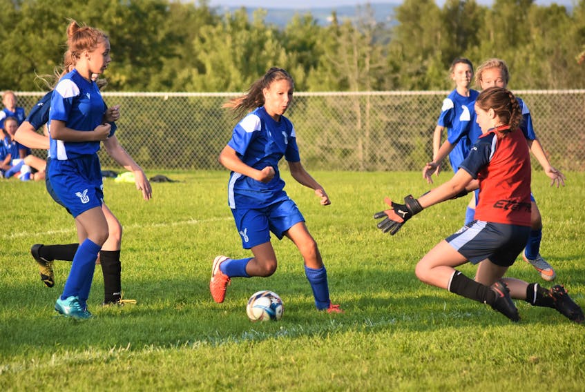 Jesse McCarron gets the CC Rider keeper to commit before moving the ball to where teammate Sophie Hatchard (not in photo) boots it home, to give North Nova United Soccer Club (NNUSC) U-13 girls a 1-0 win over their Truro opponents.