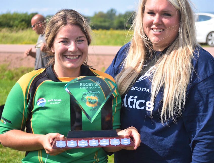 Pictou County’s Michaela Taylor accepting the trophy from Sarah O’Connor of Rugby Nova Scotia.   - Richard MacKenzie