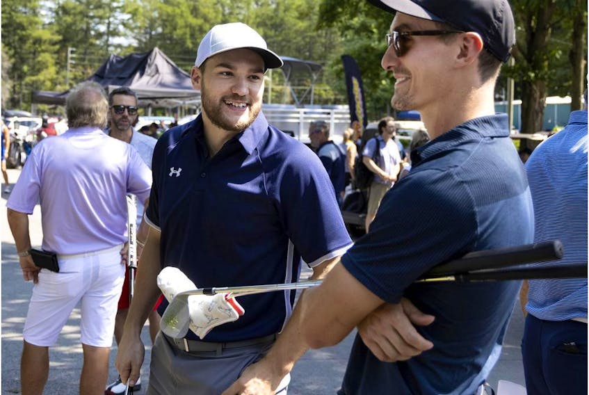 Montreal Canadiens winger Jonathan Drouin, left, and Laval Rocket centre Laurent Dauphin speak before the start of Canadiens head coach Dominique Ducharme's charity golf tournament in Joliette on Aug. 26, 2021. 