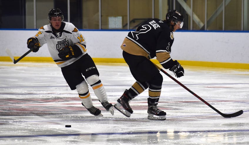 Jack Campbell of the Cape Breton Eagles, left, works his way around Xavier Delage of the Charlottetown Islanders during Quebec Major Junior Hockey League preseason action at Miners Forum in Glace Bay on Friday. Cape Breton won the game 5-2. JEREMY FRASER/CAPE BRETON POST. - Jeremy  Fraser
