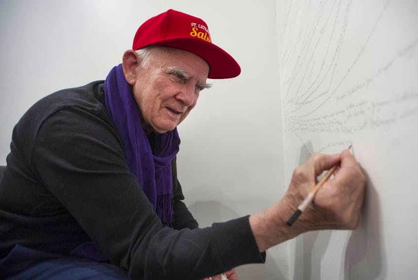 Garry Neill Kennedy works on Remembering Names, a piece that involved writing and printing the names of all art-related people he recalled meeting over the years, in October 2018, all while living with dementia. Kennedy died early this month at age 85.