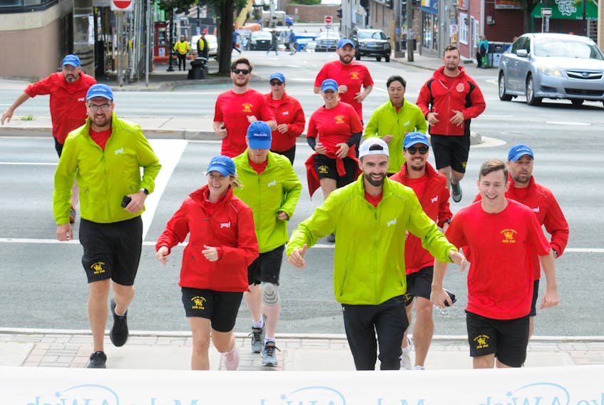 Crew members from HMCS St. John’s run for the steps of St. John’s City Hall Friday morning as they ended the 25th annual Run The Rock. The event raises money for the Newfoundland and Labrador branch of Make-a-Wish Canada (Children’s Wish Foundation).
-Joe Gibbons/The Telegram
