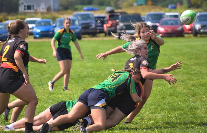Pictou County’s Lauren MacLeod makes a tackle while Michaela Taylor follows the ball. - Richard MacKenzie