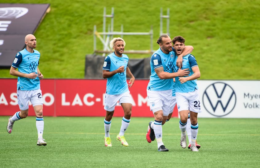 HFX Wanderers' Peter Schaale congratulates Joao Morelli (22) after his first of two goals against Atletico Ottawa on Sunday in Canadian Premier League action in Ottawa. - Canadian Premier League  