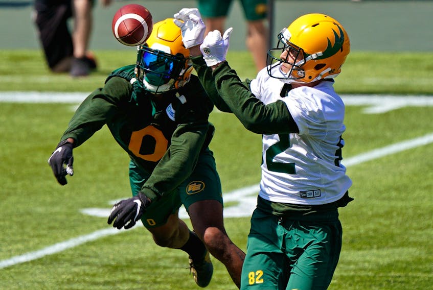 Defensive back Jonathan Rose (left) and receiver Greg Ellingson (right) reach for the ball during Edmonton Elks training camp at Commonwealth Stadium on July 12. The Elks hope Shai Ross (11) takes part in Edmonton Elks training camp at Commonwealth Stadium on July 27. The Elks hope they can run out the clock on the rest of their 10-day COVID quarantine and get back on the field to resume team activities Wednesday..