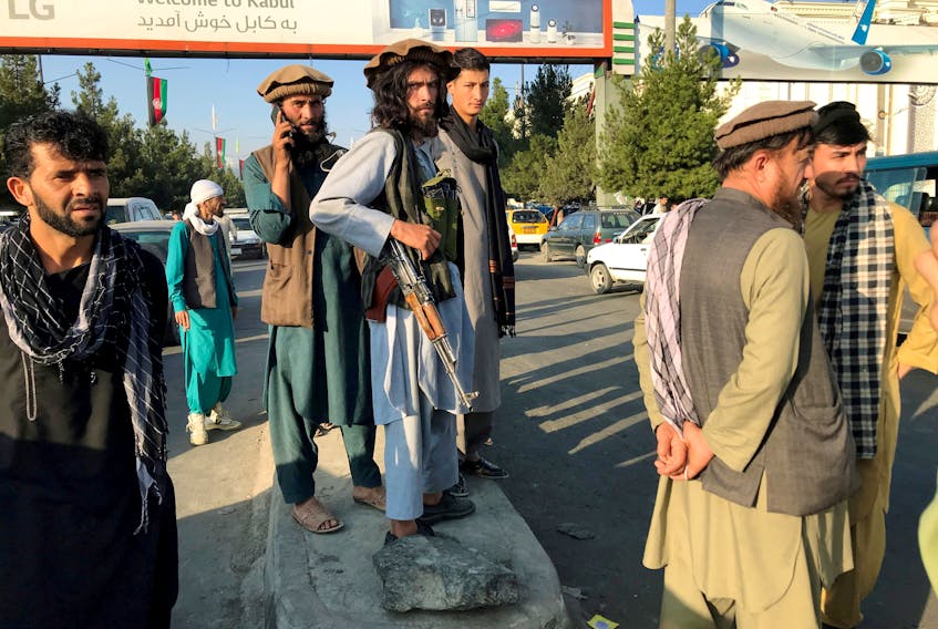 Taliban soldiers at Kabul airport, where many people are attempting to board a flight to safety in other countries. — Reuters file photo 