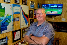 Robin Short in his man-cave garage, surrounded by press credentials and other memorabilia he collected during a career in sports journalism spanning 36 years. Short, The Telegram's long-time Sport Editor, died Sunday at 56. — Telegram file photo/Joe Gibbons