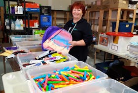 Wanda Earhart stands in the Every Woman's Centre in Sydney near their school supply donations, which they donate to students in need from primary to post-secondary school.