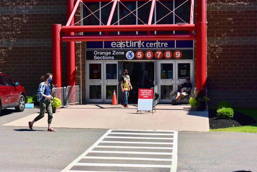A worker stands outside the Eastlink Centre in Charlottetown to check Islanders into the COVID-19 vaccination clinic. The clinic will be closing at this location later in August.
