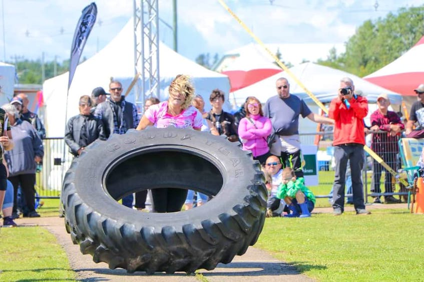 Mary Gillis participates in the tire flip portion of the fourth annual P.E.I. Strongwoman Competition in Summerside on July 31. Gillis, who competed in her first-ever strongwoman competition, finished third overall out of eight competitors. - Dawn MacInnis/Special to The Guardian