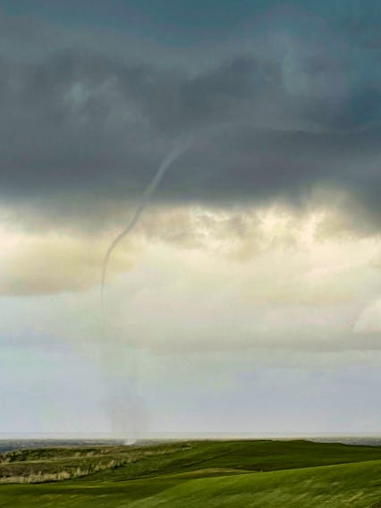 Ominous skies over the Cabot Links Golf Course last Friday prompted Margy Krause to look up. That's when she spotted this waterspout. If you look closely, you can see the spray vortex on the water.