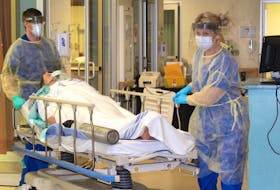 Registered nurses Jordan MacKinnon and Kerry MacVay transport a patient through the emergency department at Cape Breton Regional Hospital during a COVID-19 simulation exercise.  CONTRIBUTED-Lynn Gilbert, Nova Scotia Health