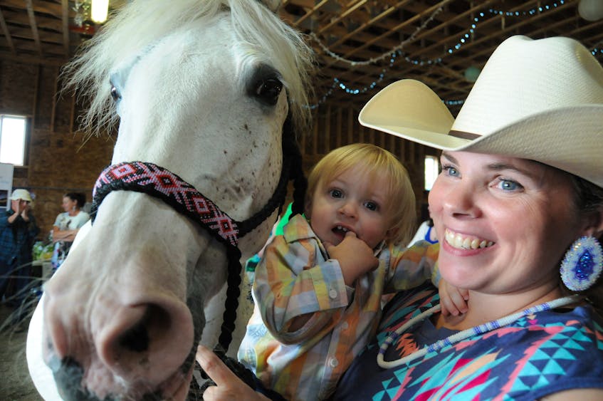 Erin Gallant and her son Andrew Butler get up close and personal with Tinker. - Joseph Gibbons