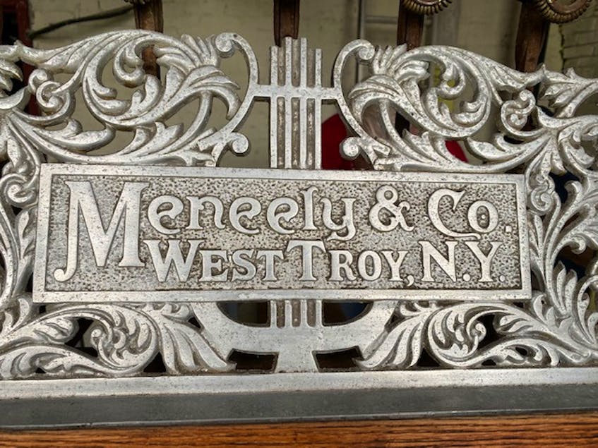 A scrollwork plaque above the wooden batons used for playing the bells features the foundry's name: MeNeely.CARLA ALLEN • TRI-COUNTY VANGUARD