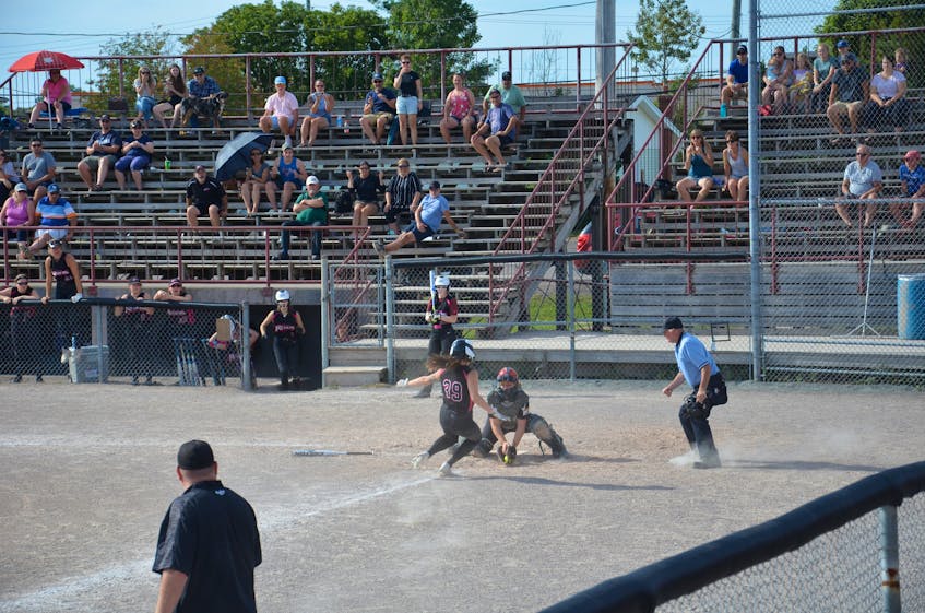 P.E.I. Chuckie’s Sports Excellence Impact catcher Kate Doyle tags out the Moncton Rebels’ Caity Allen, 39, for an out in the top of the sixth inning of the gold-medal game at the 2021 Eastern Canadian under-19 women’s fastpitch championship in Charlottetown on Aug. 30. The teams were tied 3-3 at this point. The Impact went on to win the game 7-3. - Jason Simmonds