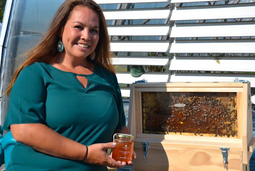 Tahirih Paul, Potlotek First Nation's economic development officer and lead on the food security project, holds a bottle of the first batch of Potlotek honey, produced in partnership with Tuckamore Homestead, a bee keeping farm on Lingan Road near Sydney. ARDELLE REYNOLDS/CAPE BRETON POST