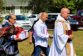 Mi'kmaq elders and Father Gerard Chaisson deliver remains of five Prince Edward Island Mi'kmaq to a cemetery outside St. Bonaventure's Parish on Aug. 29. The remains had been taken to Memorial University in 1959. 