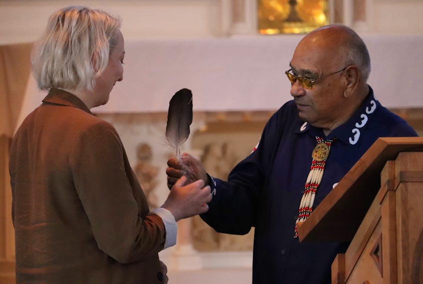 Keptin John Joe Sark, right, presents an eagle feather to scientist Alison Harris, who found the remains at Memorial University during her undergrad studies. Receiving an eagle feather is an immense honour in Mi'kmaw tradition. - Logan MacLean