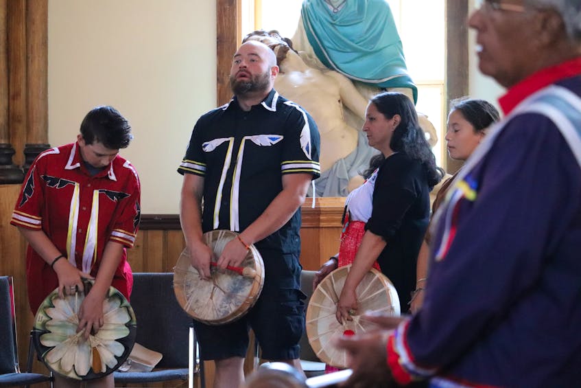 Mi'kmaq drummers stand ready as elders carry the remains into the church sanctuary at St. Bonaventure's Parish. - Logan MacLean