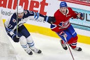  Montreal Canadiens’ Alexander Romanov and Winnipeg Jets Adam Lowry head up ice during first period of playoff game in Montreal on June 7, 2021.