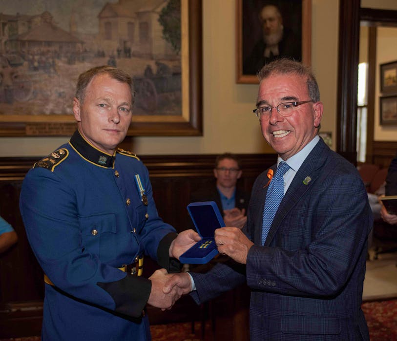 Charlottetown Mayor Philip Brown, right, presented newly-named Charlottetown Police Chief Brad MacConnell with the Governor General Exemplary Police Service 30-year medal on Aug. 30 in recognition of his decades of service as a police officer. - Contributed