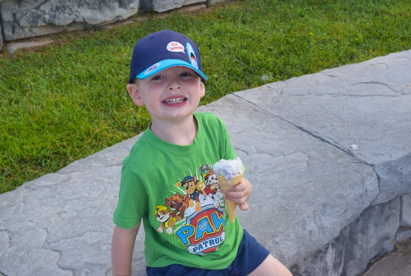 Asher Galuay enjoys a free Oxford Blueberries and Cream ice cream at the Fundy Discovery Site.