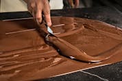 Tempering is key to ensuring chocolate's shine and snap. A team of food scientists led by Dr. Alejandro Marangoni has found a shortcut to the tabling technique pictured here that also bypasses the tempering units used in large-scale manufacturing. 