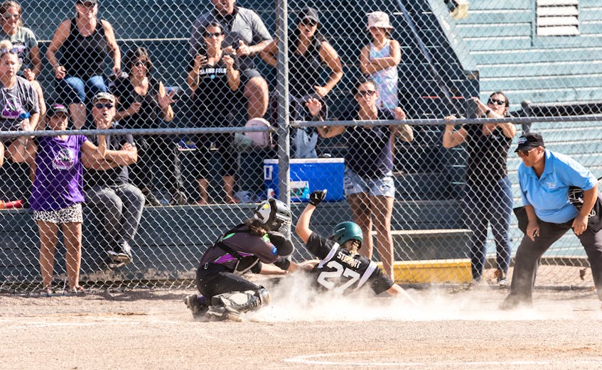 Georgia Stewart of the Riptide Surfers slides home safely with the tying run in the bottom of the sixth inning of the 2021 Eastern Canadian under-12 female fastpitch championship in Summerside on Aug. 29. Emma Murphy followed Georgia home with the game-winning run as the Surfers defeated the Sydney Venom from Nova Scotia 3-2 in the gold-medal game.  - Roma Collett • Special to The Guardian