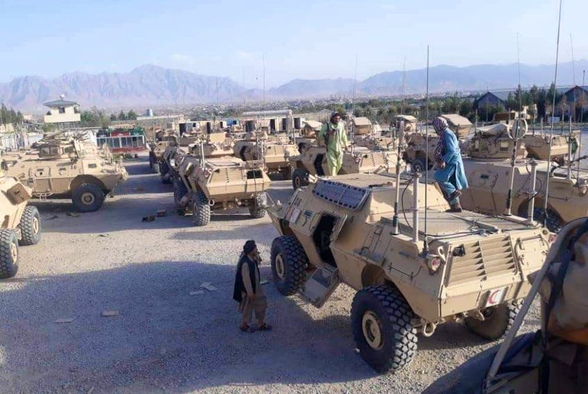 Taliban fighters with captured M117 vehicles at Kabul airport. 