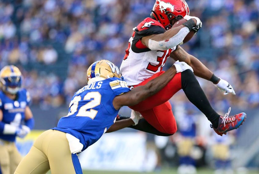  Calgary Stampeders RB KaÕDeem Carey (right) leaps into the end zone past Winnipeg Blue Bombers CB Deatrick Nichols during CFL action against the Winnipeg Blue Bombers at IG Field in Winnipeg on Sun., Aug. 29, 2021.
