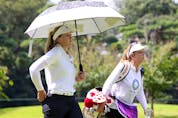  Brooke Henderson of Team Canada and caddie Brittany Henderson walk down to the sixth hole during the first round.