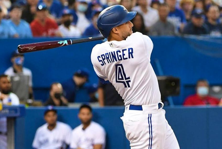 Toronto Blue Jays designated hitter George Springer (4) hits a two-RBI double against Cleveland Indians in the third inning at Rogers Centre.  