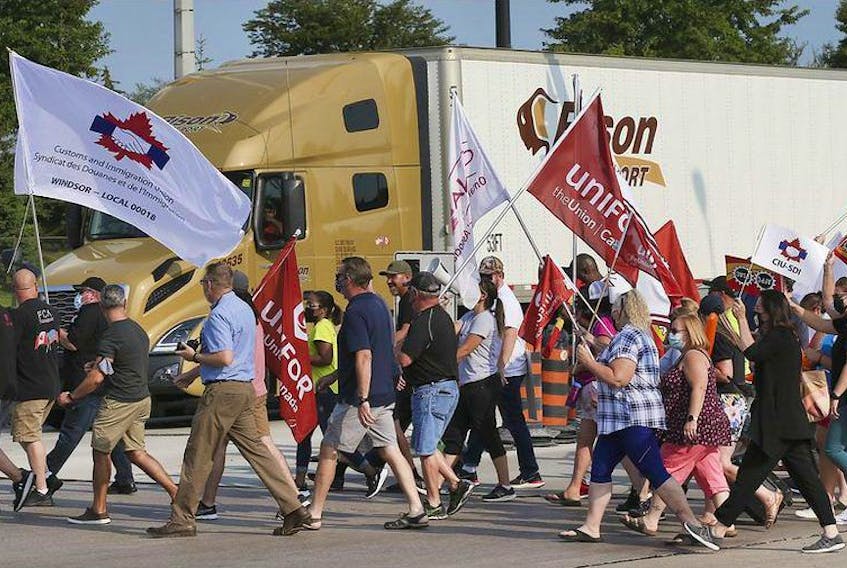  Members of the Customs and Immigration Union and their supporters participate in a rally near the Ambassador Bridge in Windsor on Wednesday, August 4, 2021.
