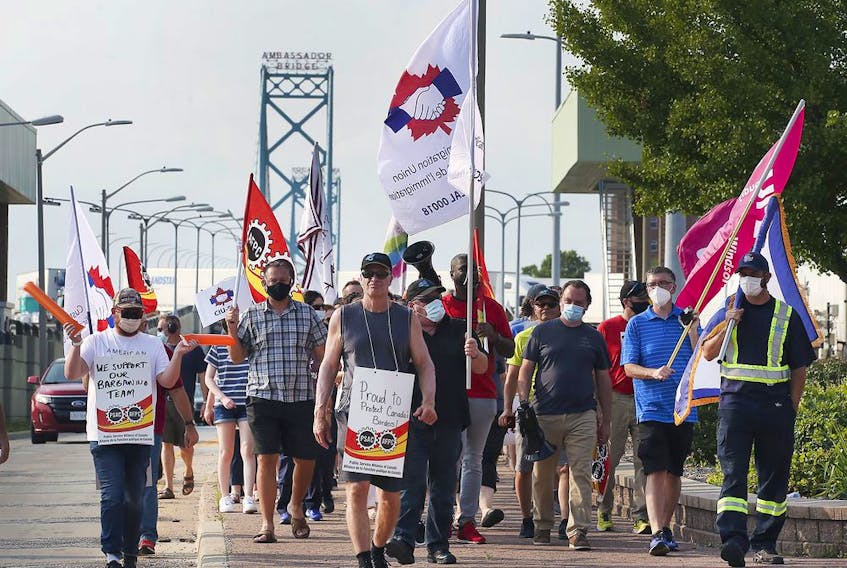 Members of the Customs and Immigration Union and their supporters participate in a rally near the Ambassador Bridge in Windsor on Wednesday, August 4, 2021.