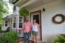Marlies Van Sloten and Andrew Skowby in front of the formerly abandoned home in Springfield.
