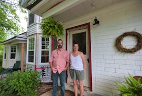 Marlies Van Sloten and Andrew Skowby in front of the formerly abandoned home in Springfield.