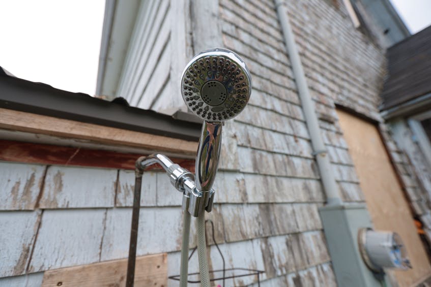 Andrew Skowby installed an outdoor shower to use while gutting the inside of his house in Springfield. - Eric Wynne
