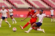  KASHIMA, JAPAN – AUGUST 02: Crystal Dunn #2 of Team United States shoots whilst under pressure from Christine Sinclair #12 of Team Canada during the Women’s Semi-Final match between USA and Canada on day ten of the Tokyo Olympic Games at Kashima Stadium on August 02, 2021 in Kashima, Ibaraki, Japan.