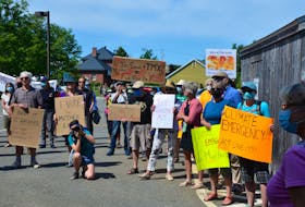 Demonstrators gather outside the constituency office of Kings-Hants MP Kody Blois in Wolfville to demand climate crisis action as part of the national Canada on Fire Day of Action on July 29. KIRK STARRATT