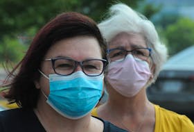 Two women wear masks Friday, Aug. 6, while attending a rally protesting the ferry service to Bell Island, at the Confederation Building in St. John’s. Chief Medical Officer of Health Dr. Janice Fitzgerald announced Friday that as of 12:01 a.m. Tuesday wearing masks in public places will no longer be mandatory. JOE GIBBONS • THE TELEGRAM