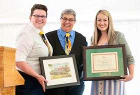 Kate Krug accepts an award for teaching excellence from Cape Breton University in 2019. From left, Eli Quirk, Krug and Kelsea MacNeil. CONTRIBUTED