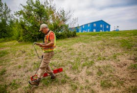 Archaeologist Jonathan Fowler, uses an electro-magnetometer near the site of the former Shubenacadie residential school near Shubenacadie, N.S., on July 12, 2021. Fowler is taking part in the burial investigation and led the search of the grounds that did not find evidence of remains connected to the institution, which operated between 1930 and 1966. FILE PHOTO