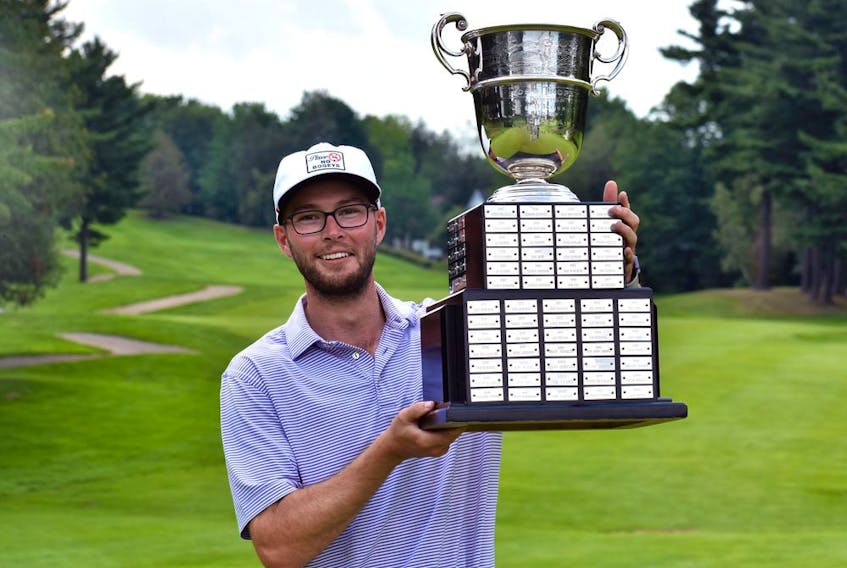 Riley Fleming, a teaching professional at Lynx Ridge in Calgary, lifts the P.D. Ross Trophy after winning the 2021 BetRegal PGA Championship of Canada. (Courtesy of PGA of Canada)